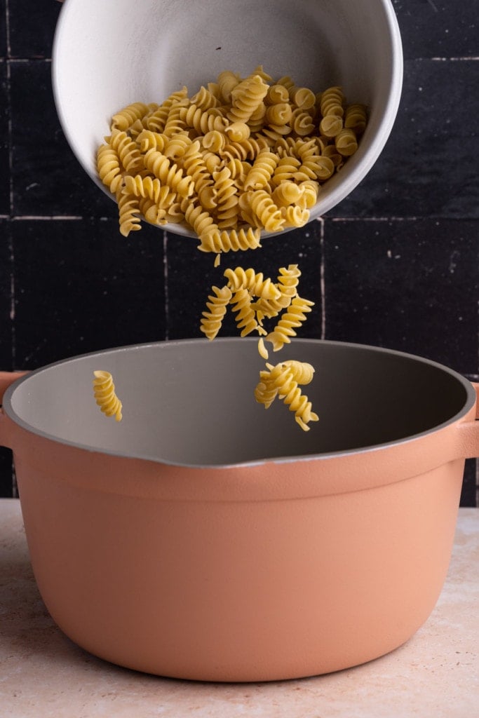 Adding Rotini pasta to pot to boil
