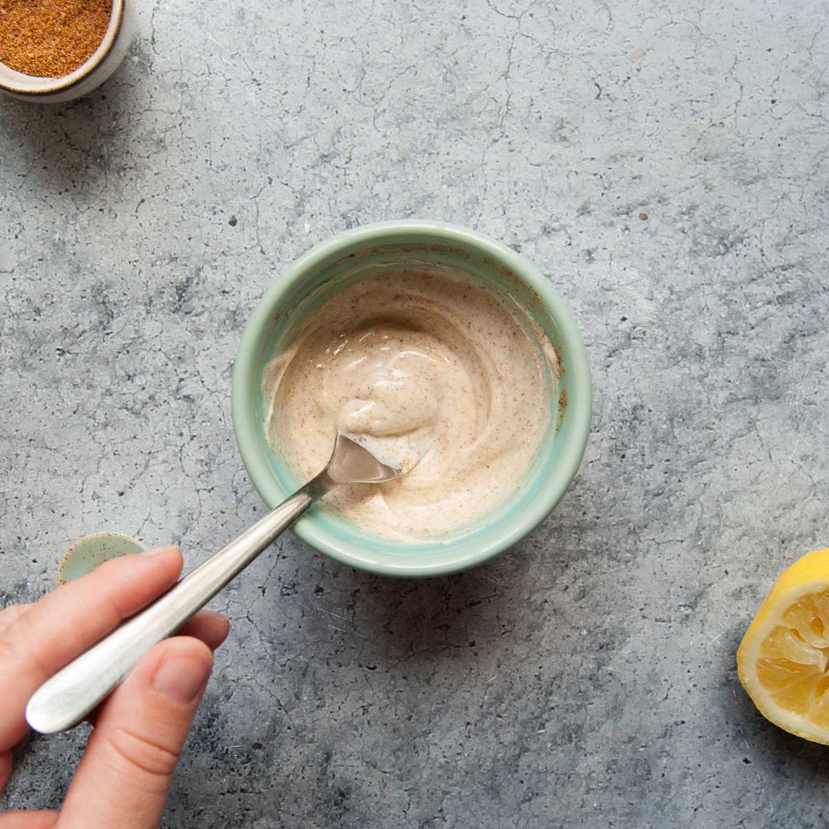 Quick 3-ingredient old bay aioli being mixed with a fork.