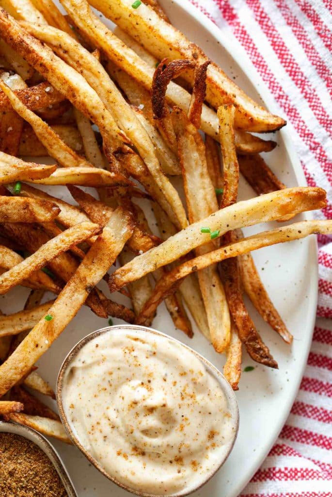 close up of baked fries with old bay seasoning
