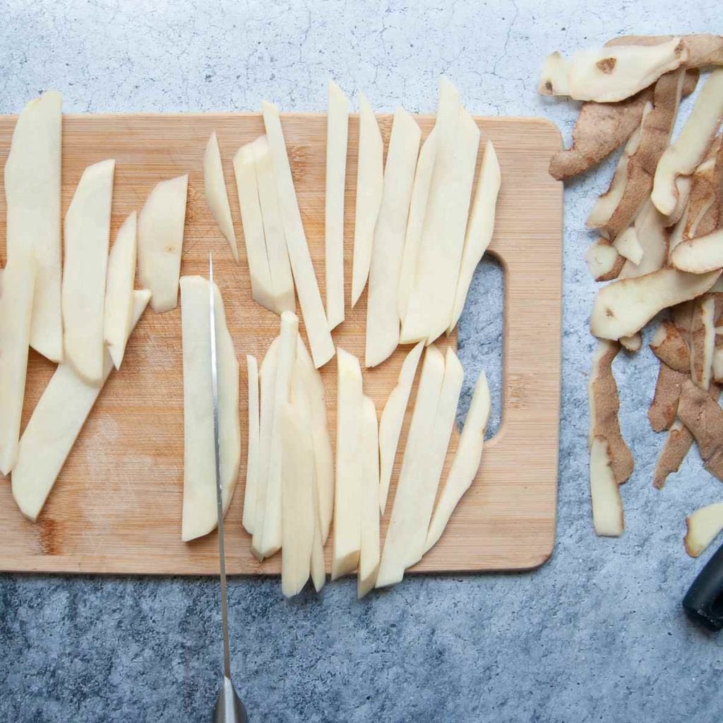 cutting potatoes in strips to make fries
