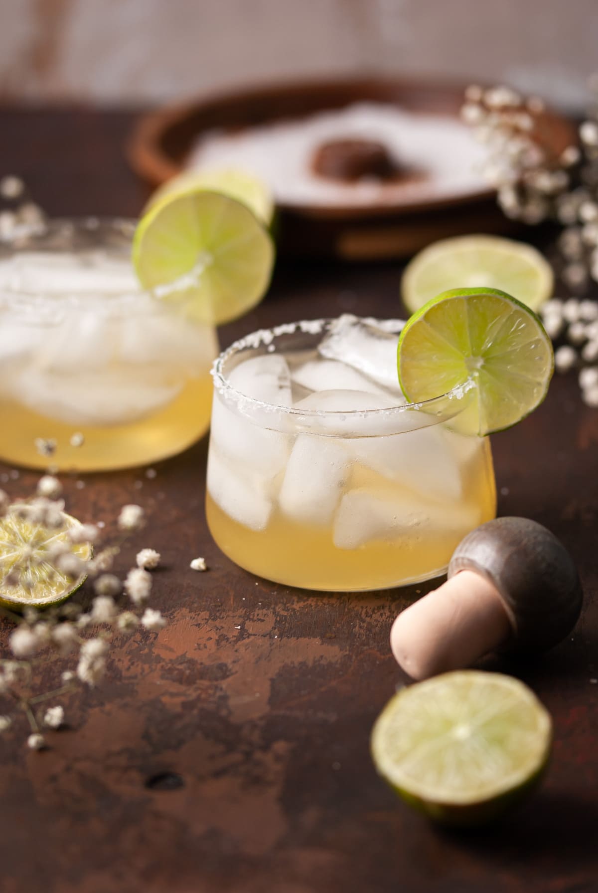 Two Cocktails garnished with lime and a salt rim