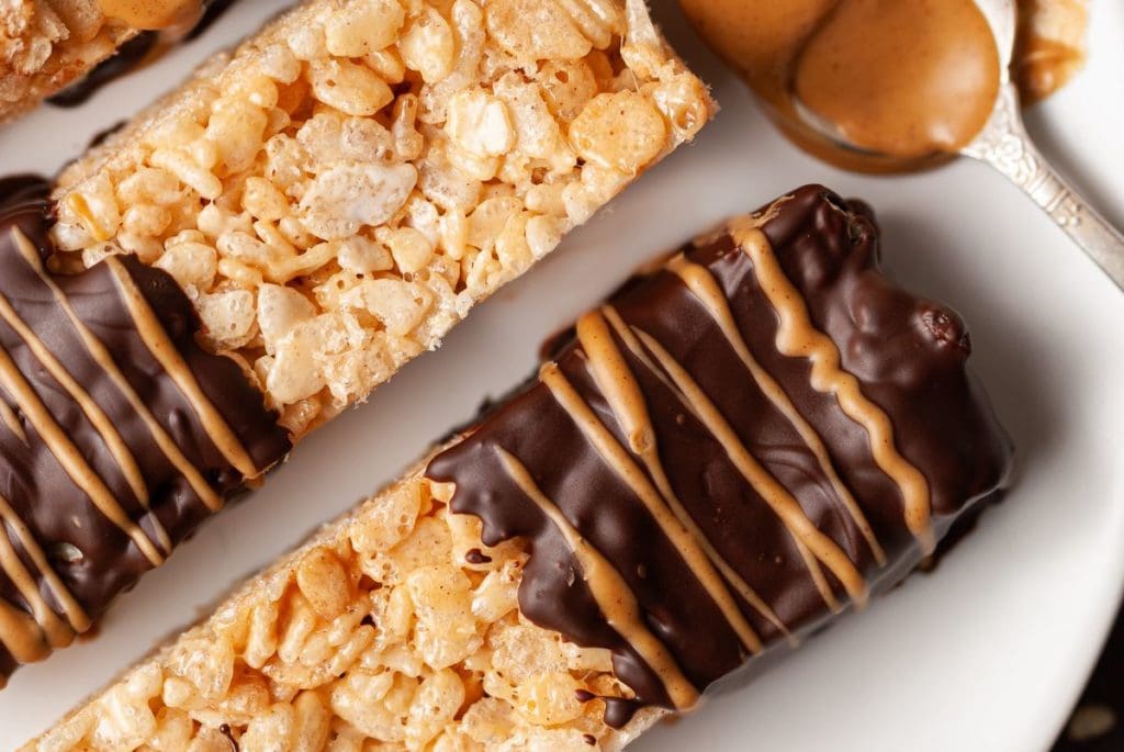 close up of cereal treats with chocolate and peanut butter drizzle
