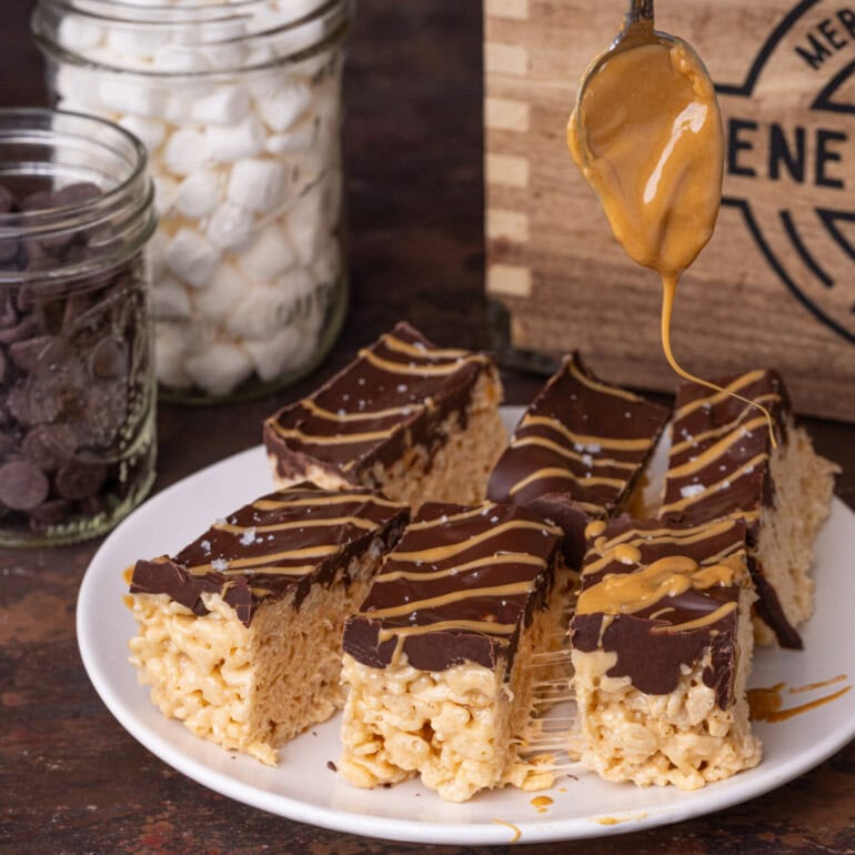 Drizzling extra peanut butter on top of chocolate peanut butter rice krispies treats.