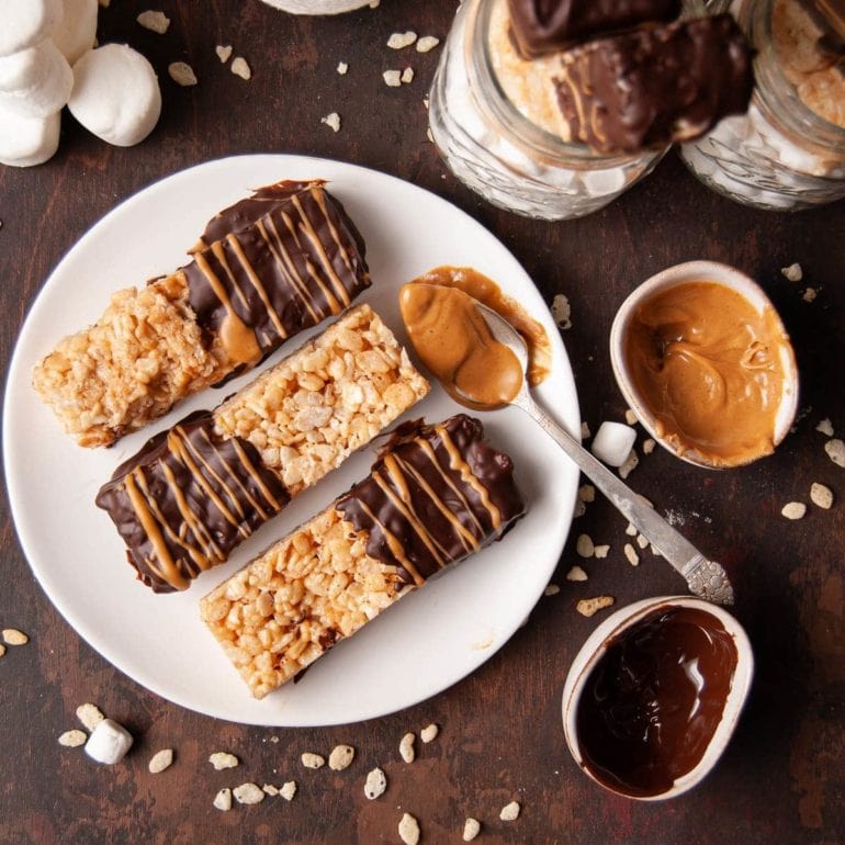 peanut butter rice krispie treats dipped in chocolate and then drizzled with peanut butter