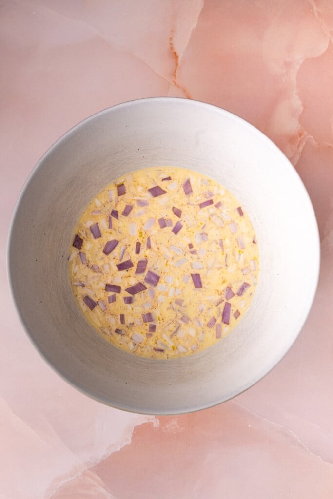 Seasoned egg wash with diced shallots before adding to savory French toast bake. 