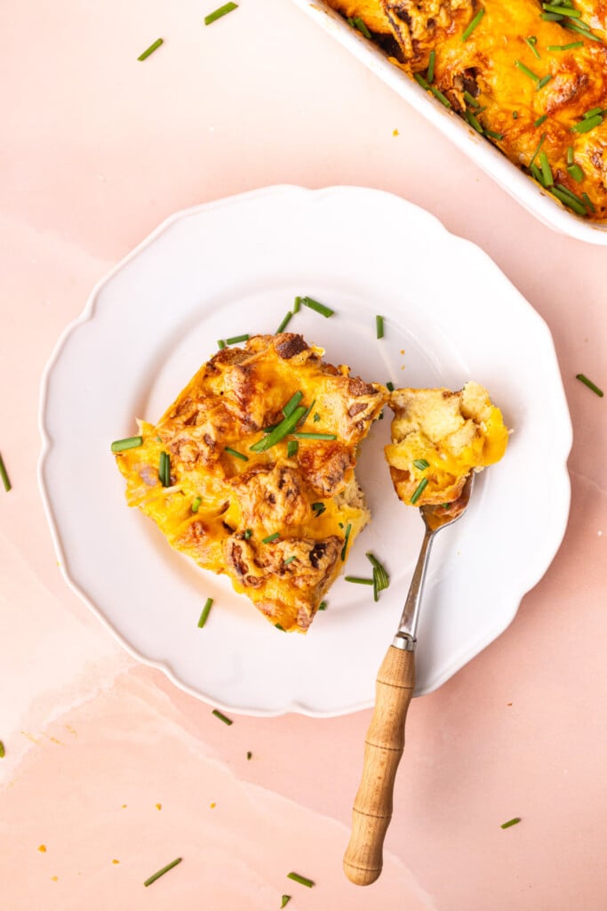 Overhead image of white plate with savory French toast and a fork. 