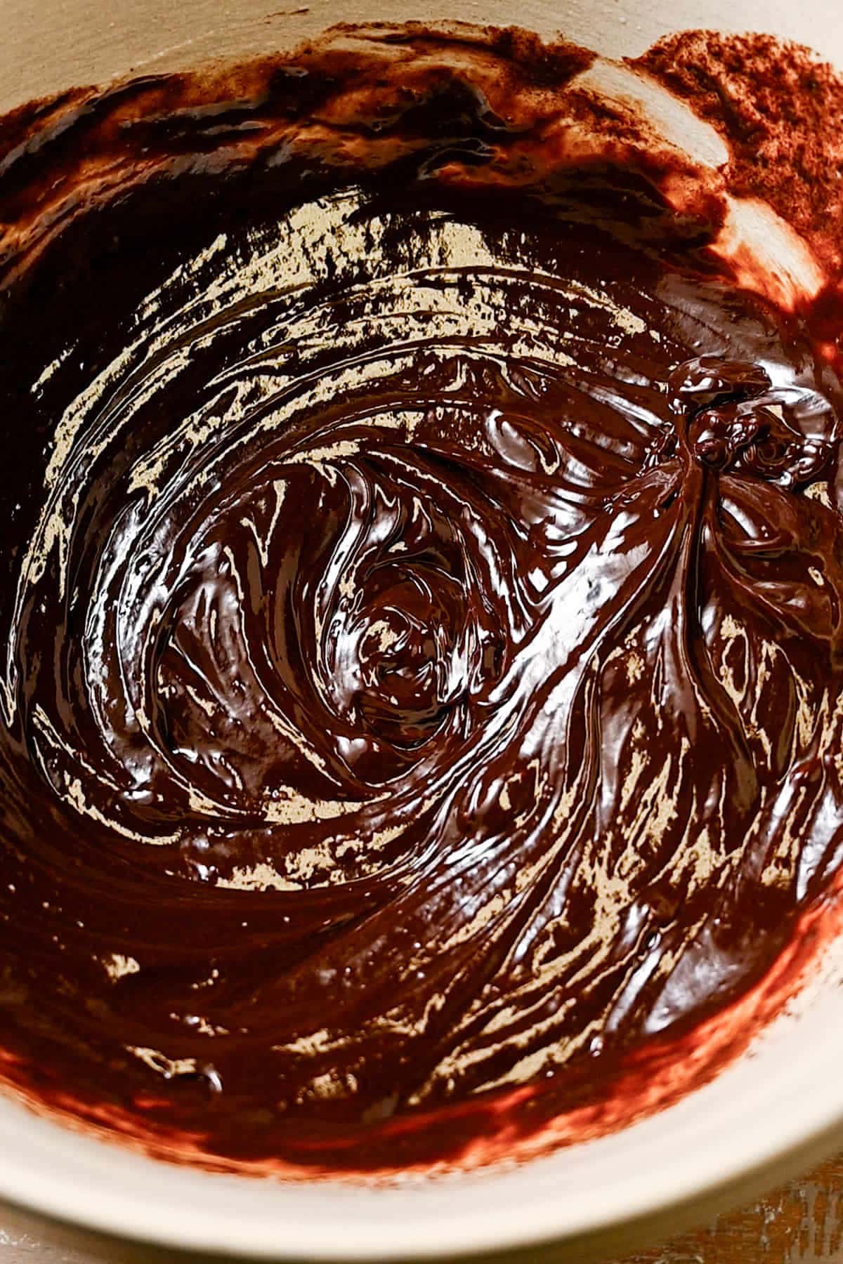 Chocolate chips melted and whisked into hot cream and butter. 
