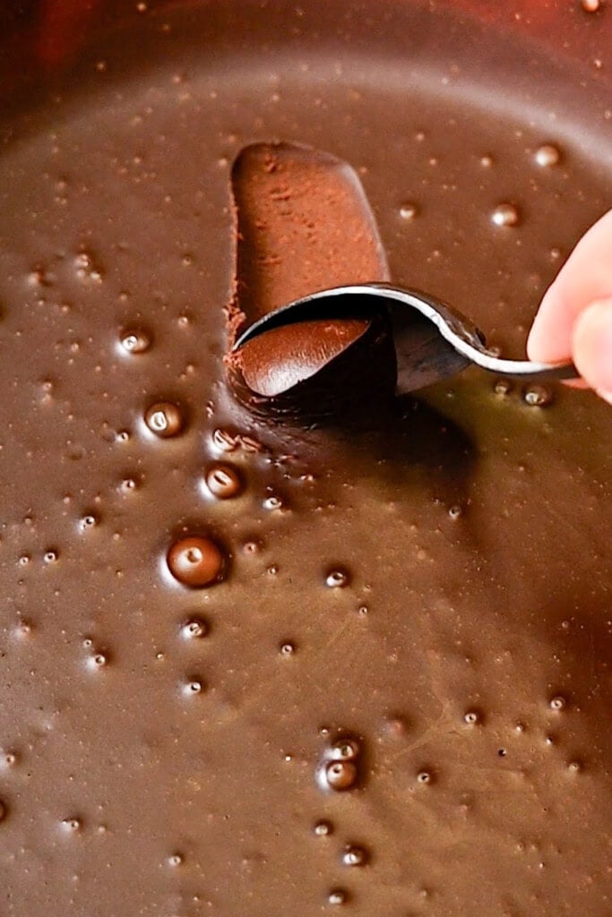 Scooping out chocolate truffle mixture to form them into balls.