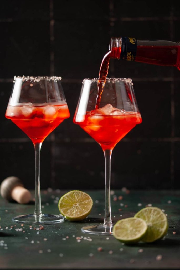 Pouring Aperol Into Glass With Ice