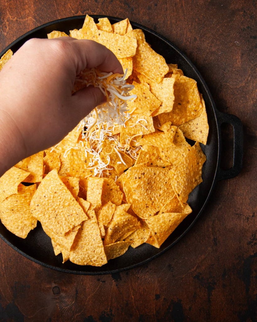 Adding Shredded Cheese to Tortilla Chips