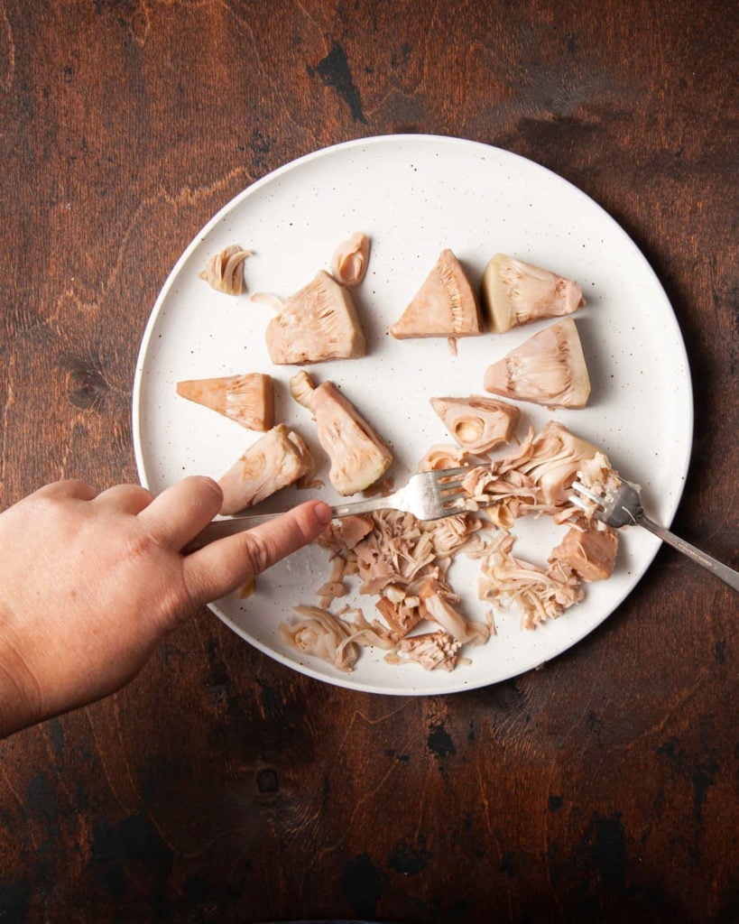 shredding tender jackfruit with two forks