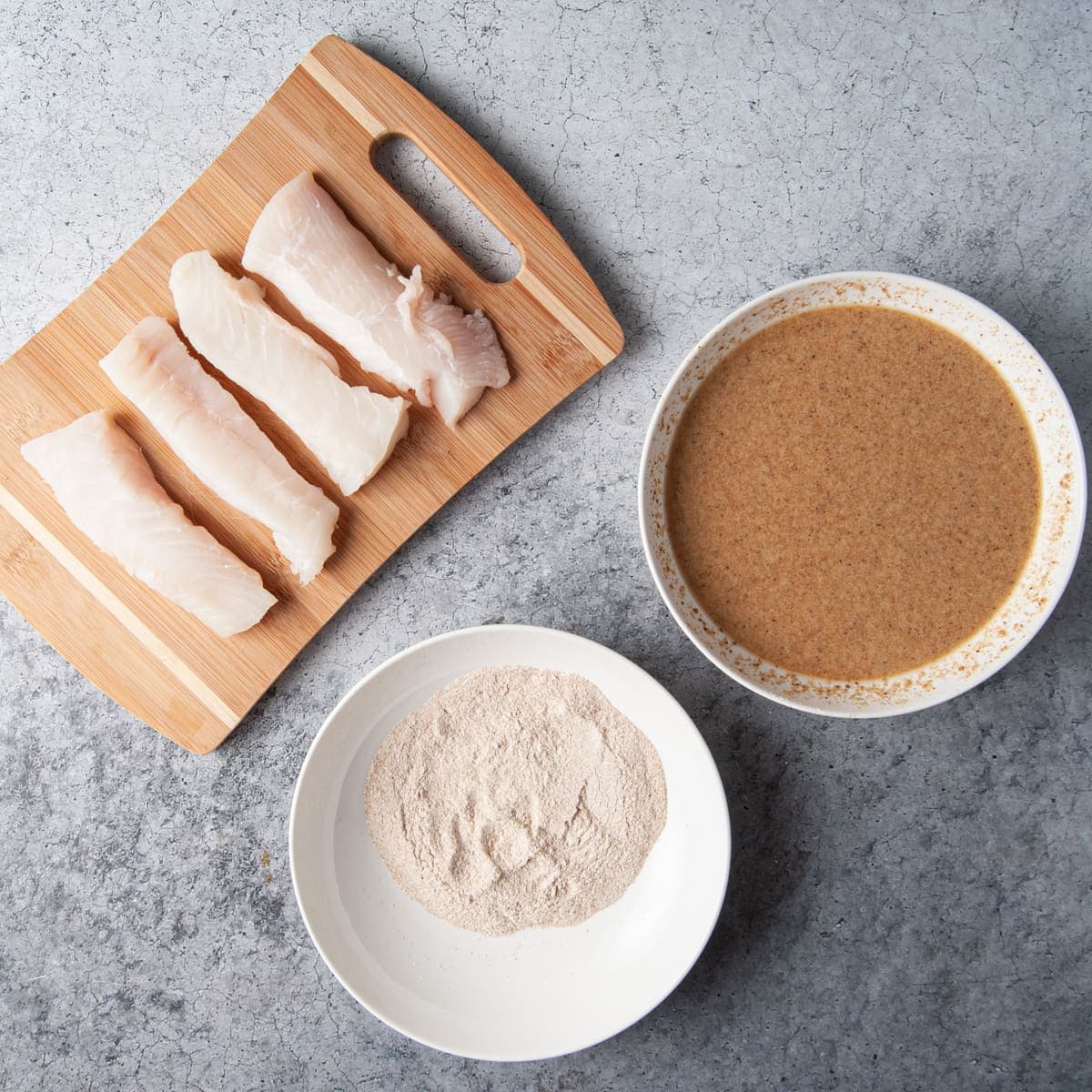 assembly line for coating halibut in flour and batter