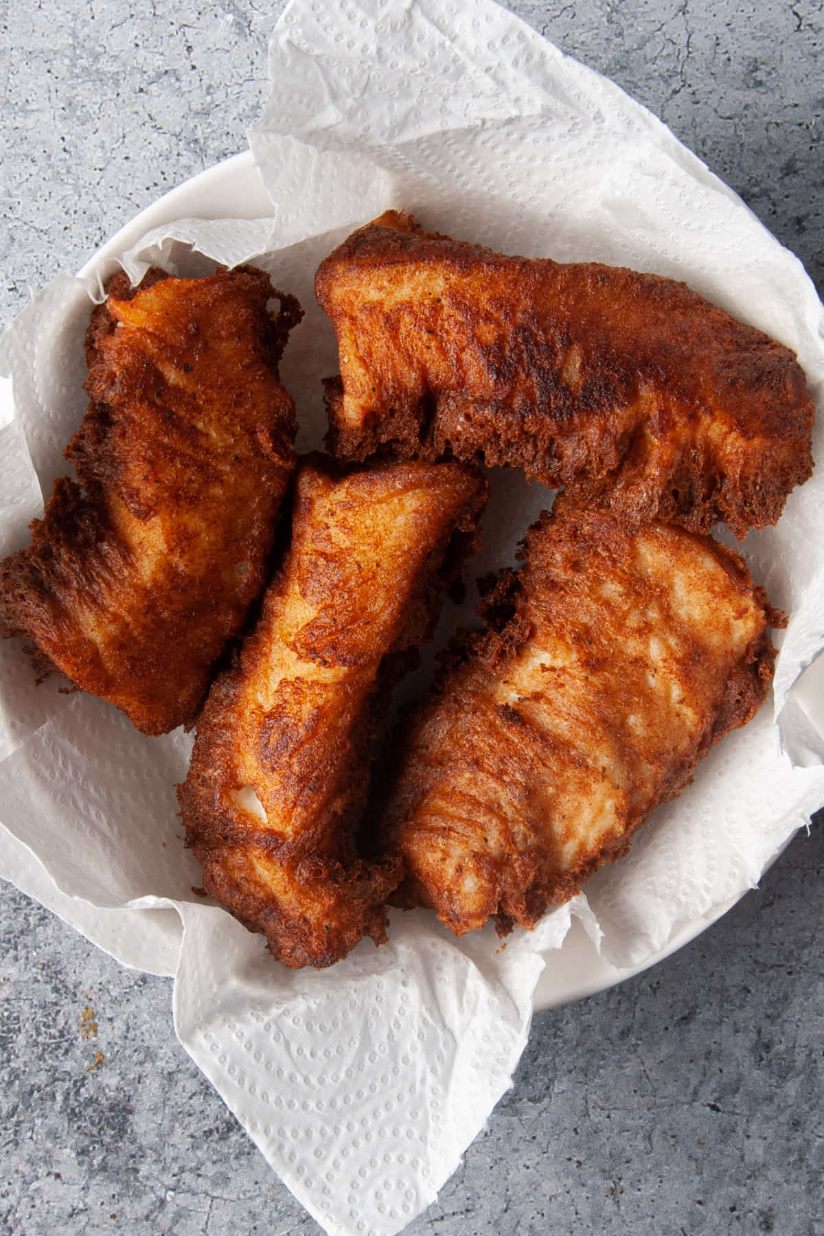 Fried fish on paper towel to soak up extra grease.