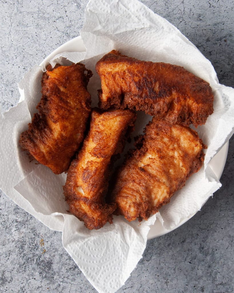 fried fish on paper towel to soak up extra grease