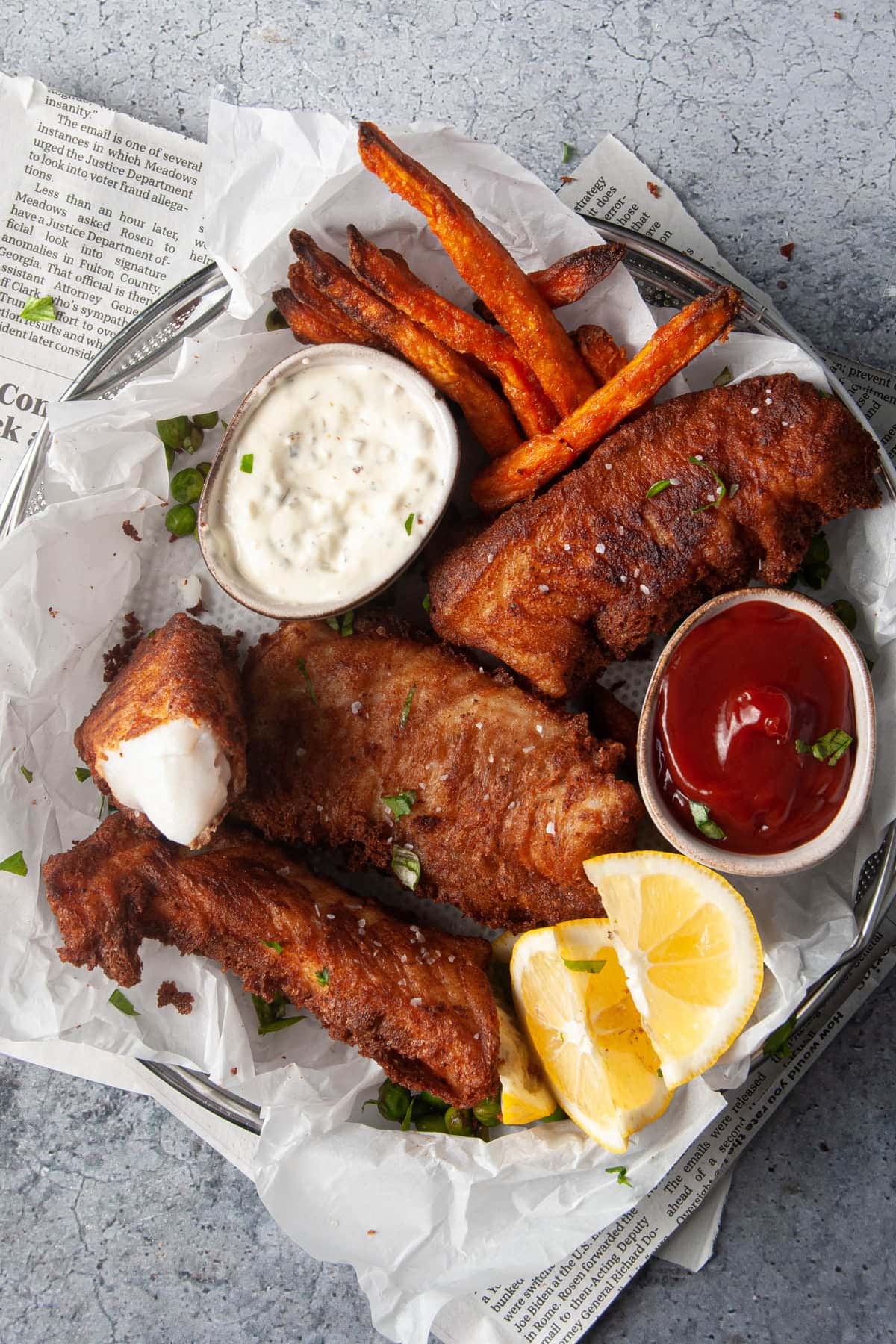 Platter of Beer Battered Fish with One Piece Split open to reveal Flaky Halibut