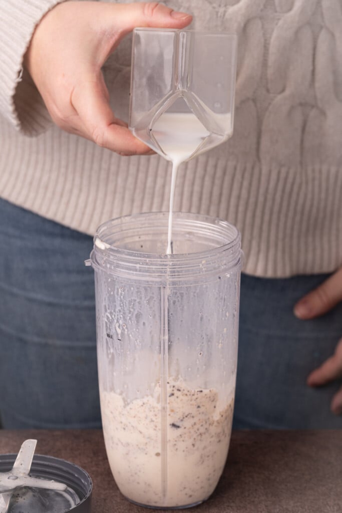 Adding more milk to a cookie dough milkshake to thin it out. 