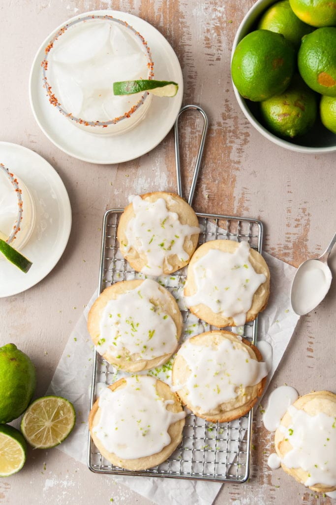 portrait of glazed shortbread cookies surrounded by margaritas and limes