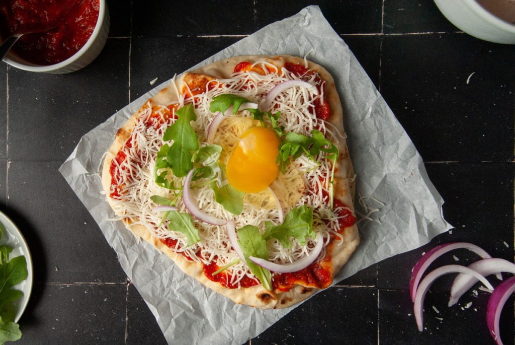 Cracking an Egg onto Naan Pizza