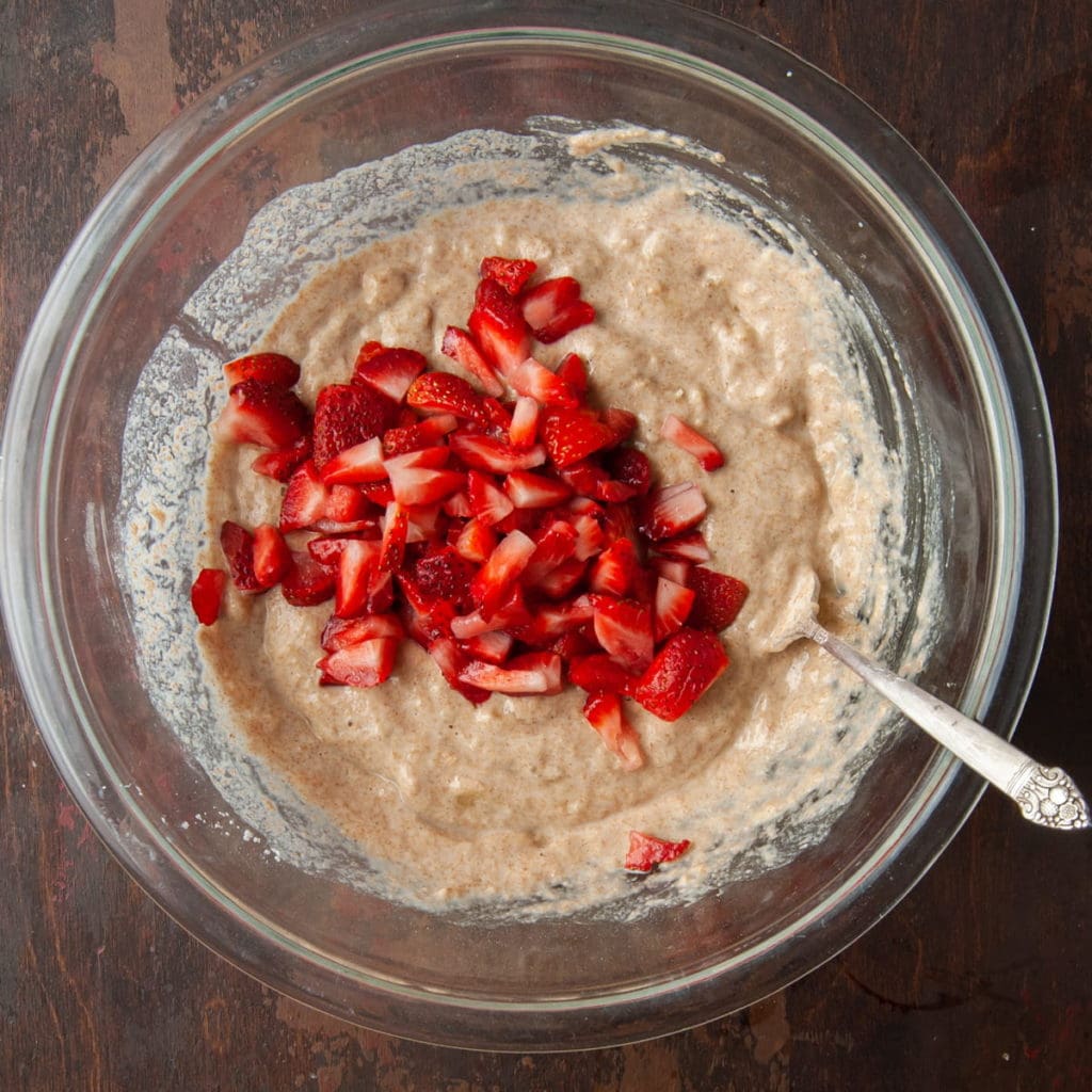 strawberries being folded into whole wheat banana pancake batter