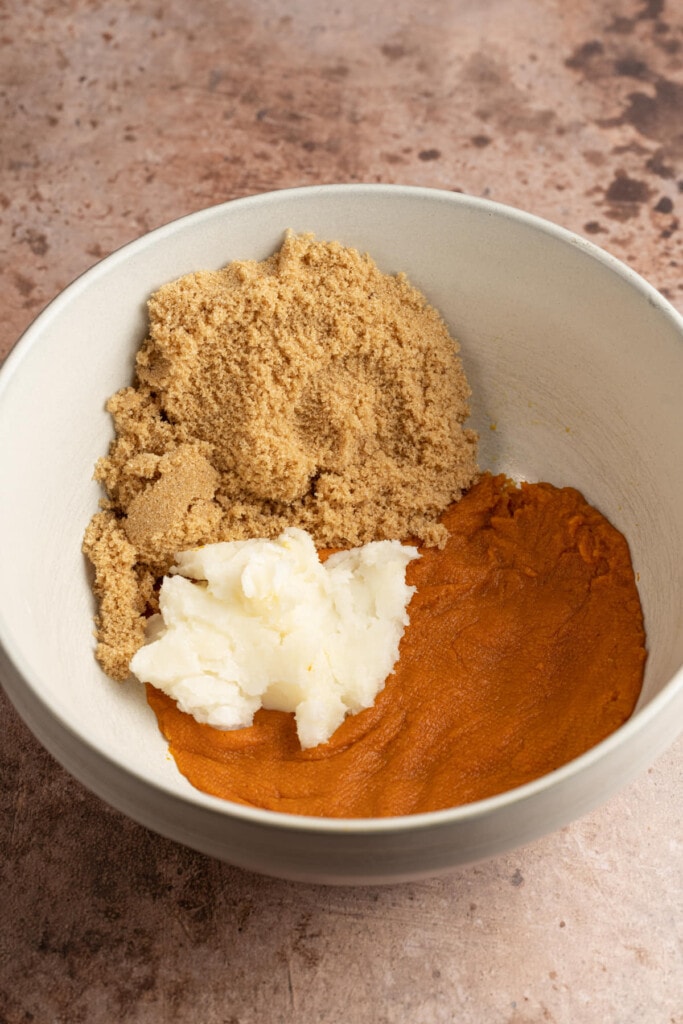 Brown sugar, coconut oil, and pumpkin puree in a large mixing bowl