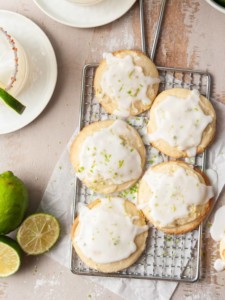 portrait of glazed shortbread cookies surrounded by margaritas and limes