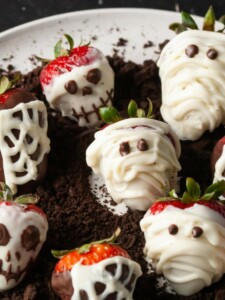 chocolate covered strawberries decorated with spiderwebs mummies and skeletons