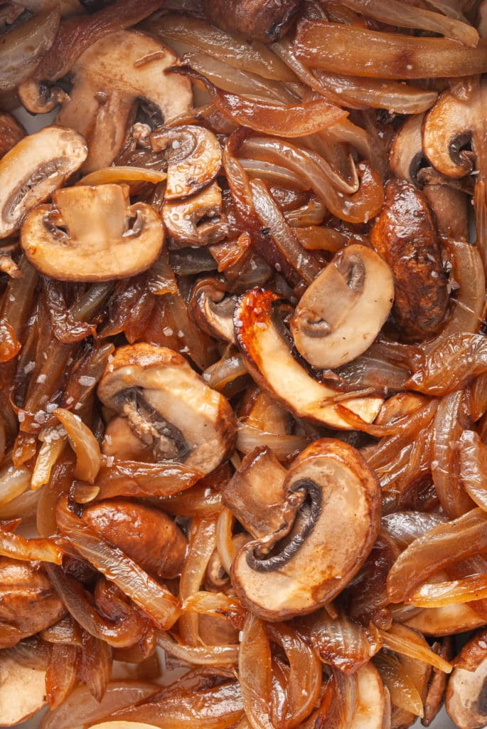 close up of cooked mushrooms and onions