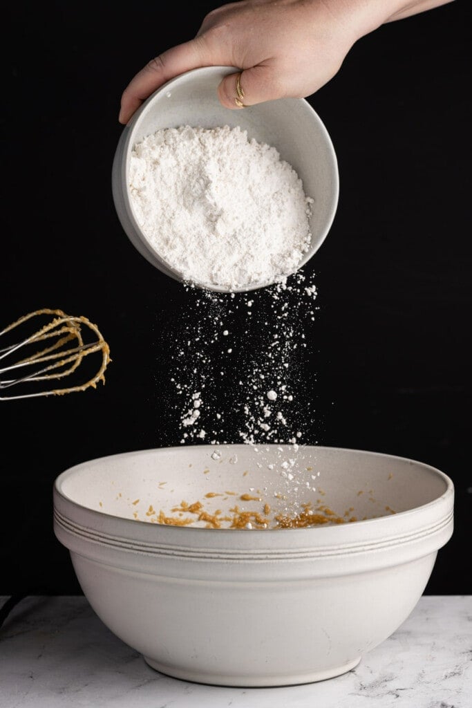 Adding all-purpose flour to Peanut Butter Banana Chocolate Chip Muffin batter