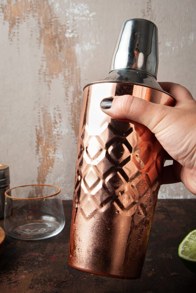 shaking a copper cocktail shaker