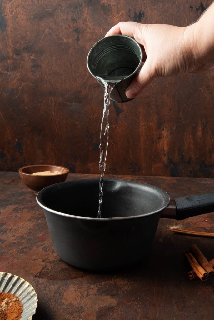adding water to a small pot