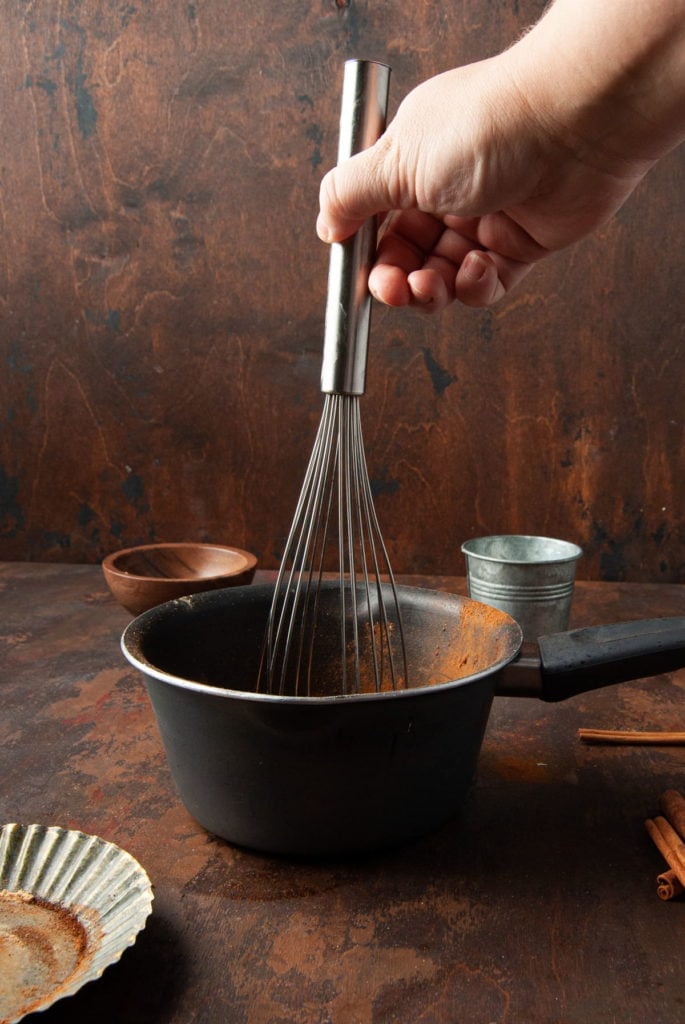 Using A Whisk to Combine Sugar, Water, and Spices