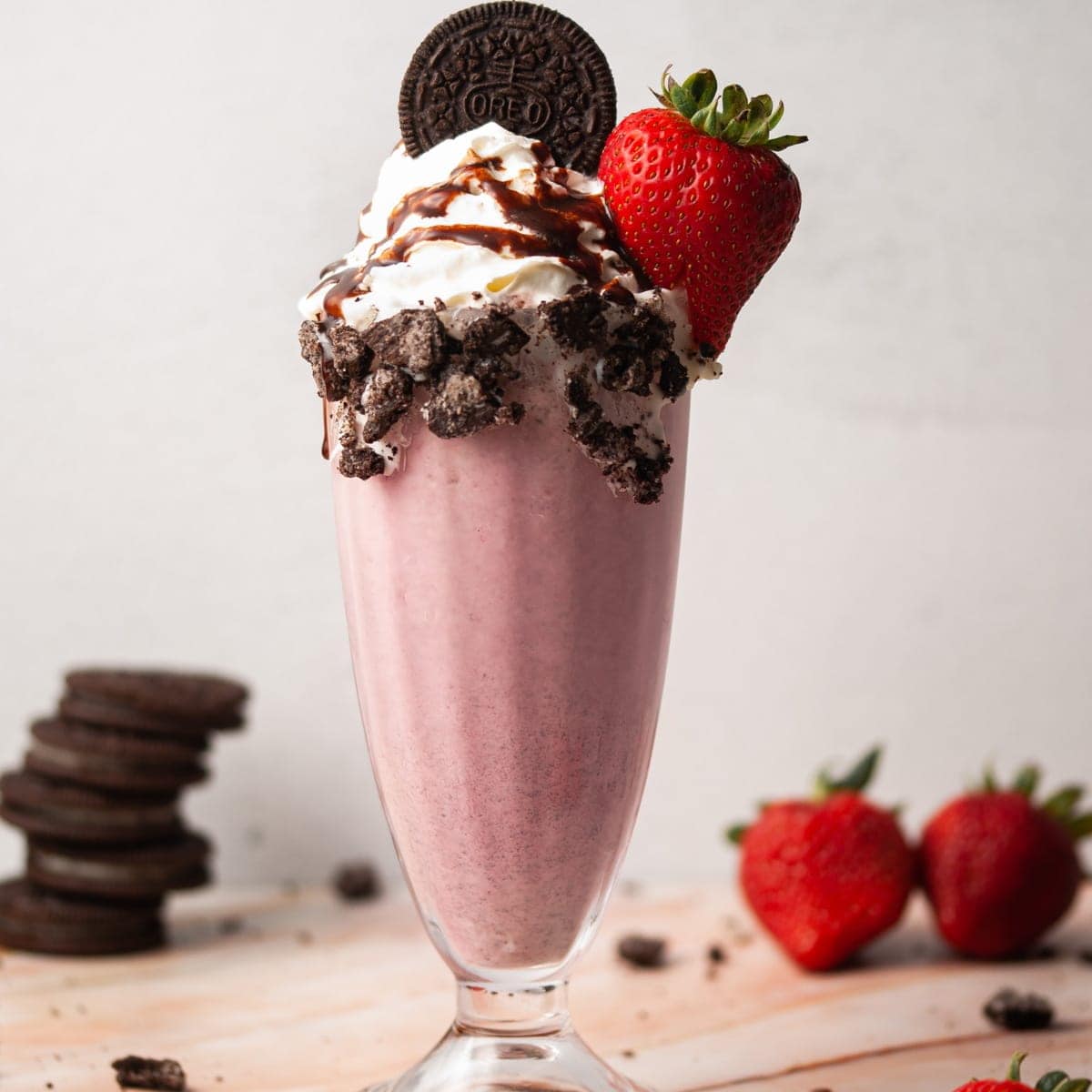 Banana, strawberry and chocolate milkshake in plastic cup with