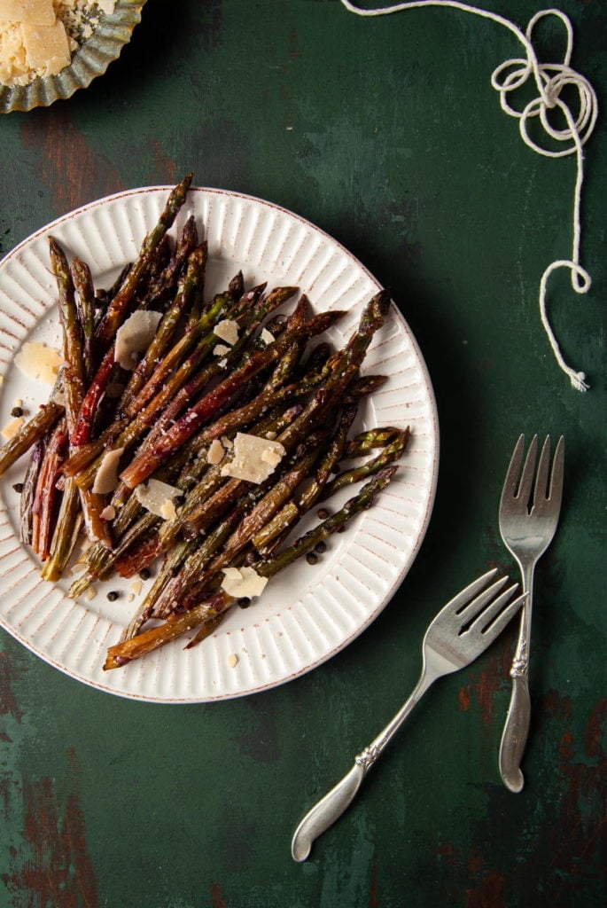 platter of purple asparagus with two forks next to it
