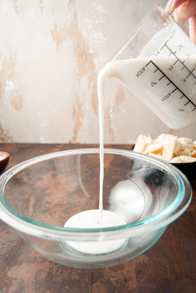 adding coconut milk to mixing bowl