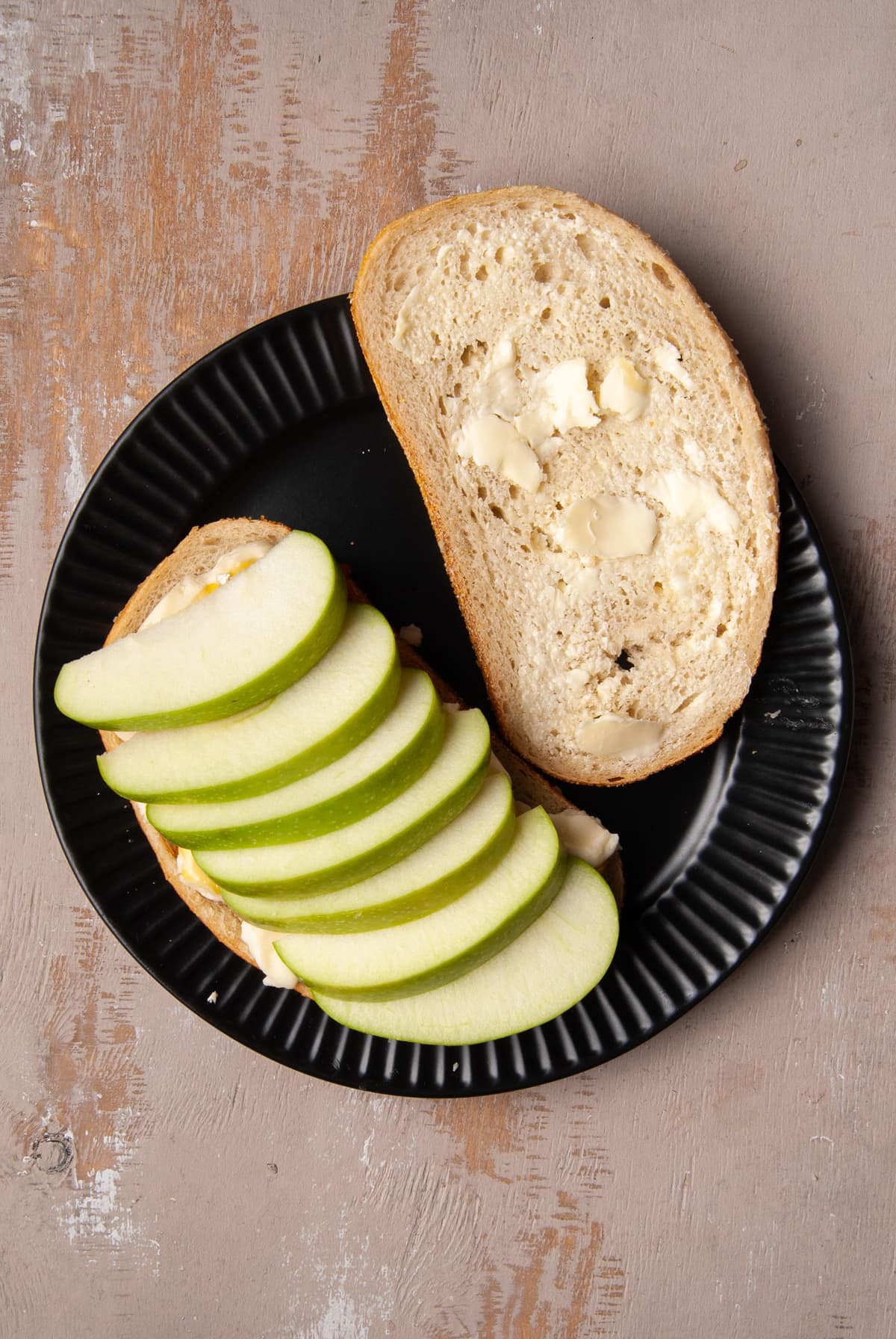 thinly sliced apple layered evenly on top of bread