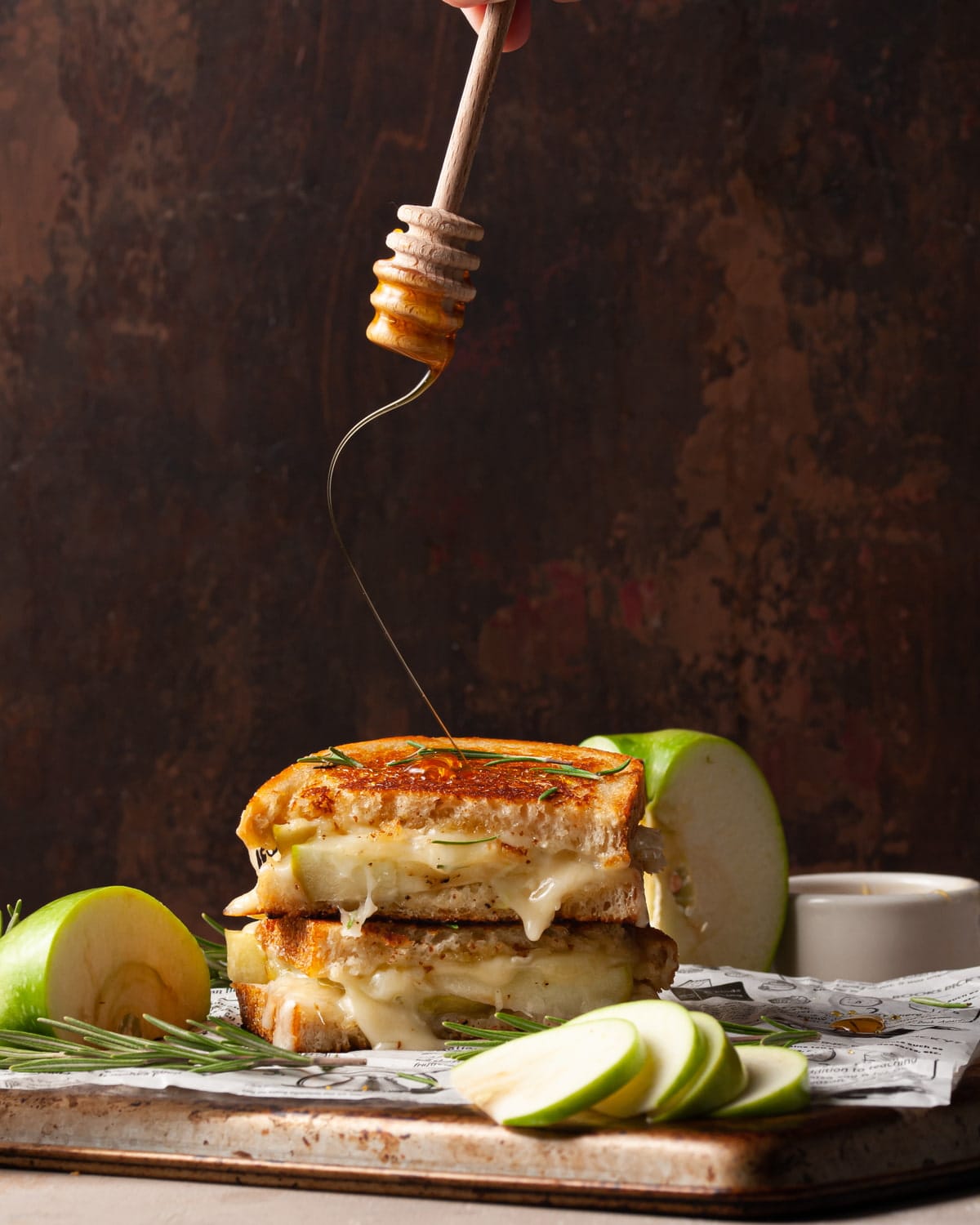 dripping honey over top a grilled cheese sandwich