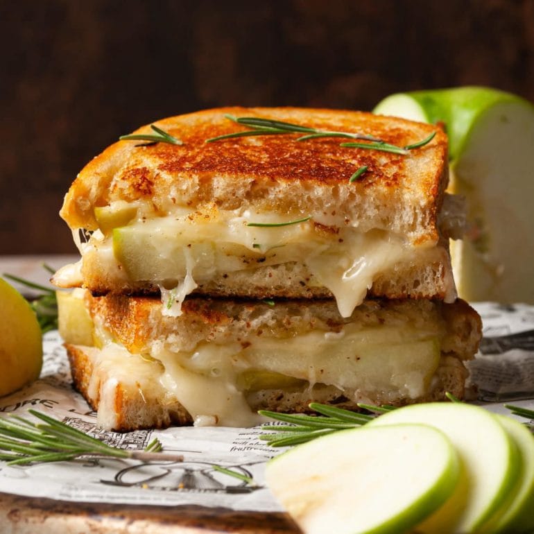 grilled cheese with brie oozing out and apple slices