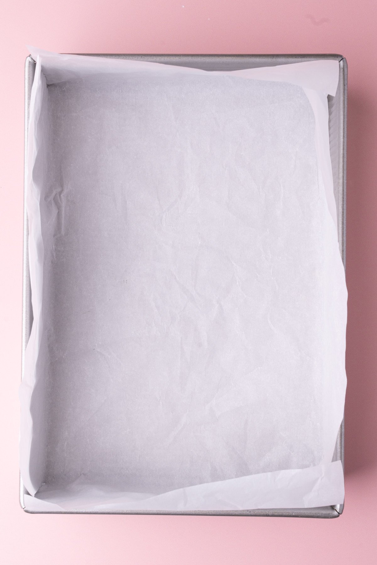 9x13-inhc rectangular baking pan lined with parchment paper. 