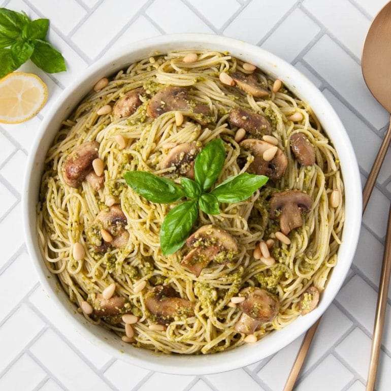 overhead shot of serving bowl filled with mushroom pesto pasta