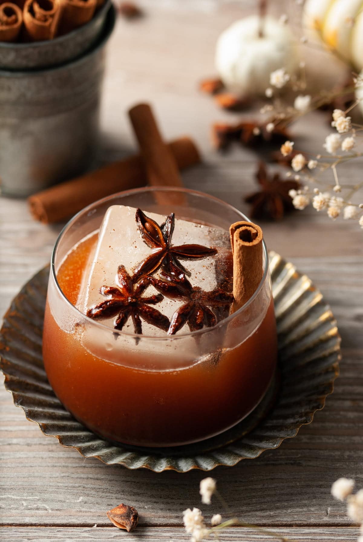 overhead shot of fall cocktail with big whiskey ice with star anise inside