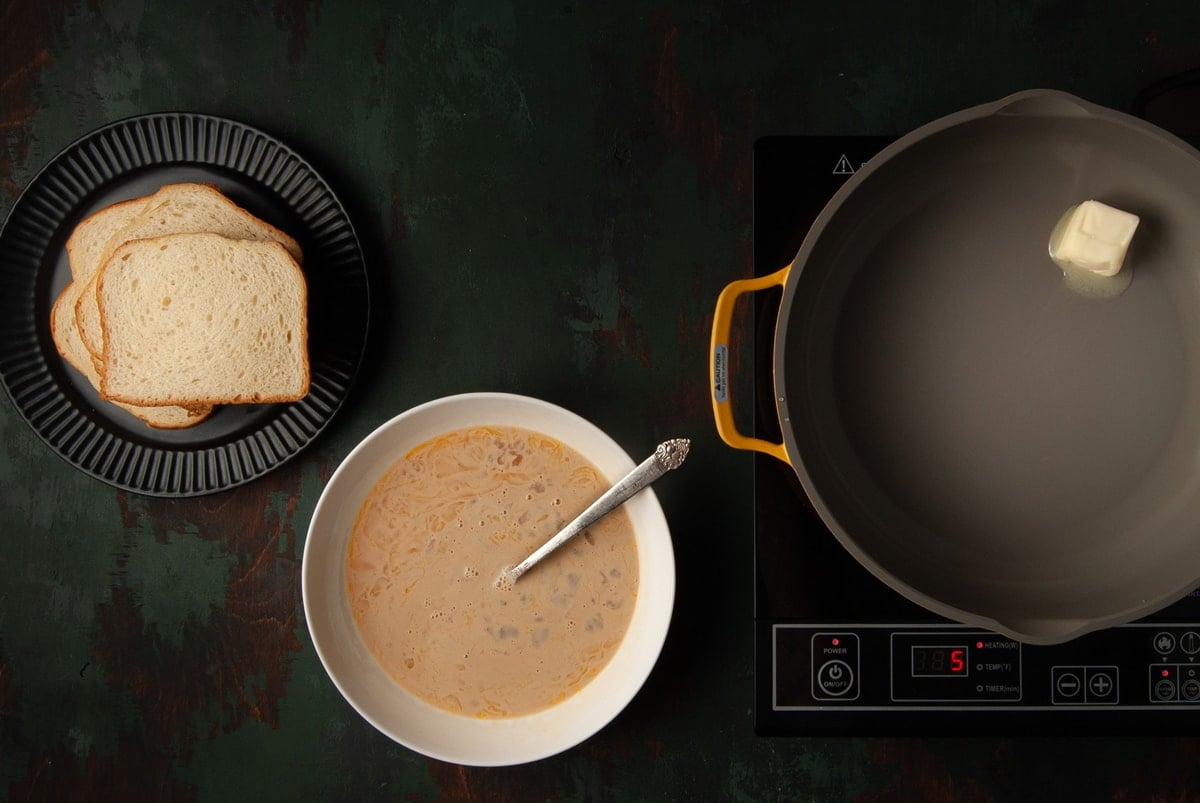 bread, egg wash, and butter in pan getting hot