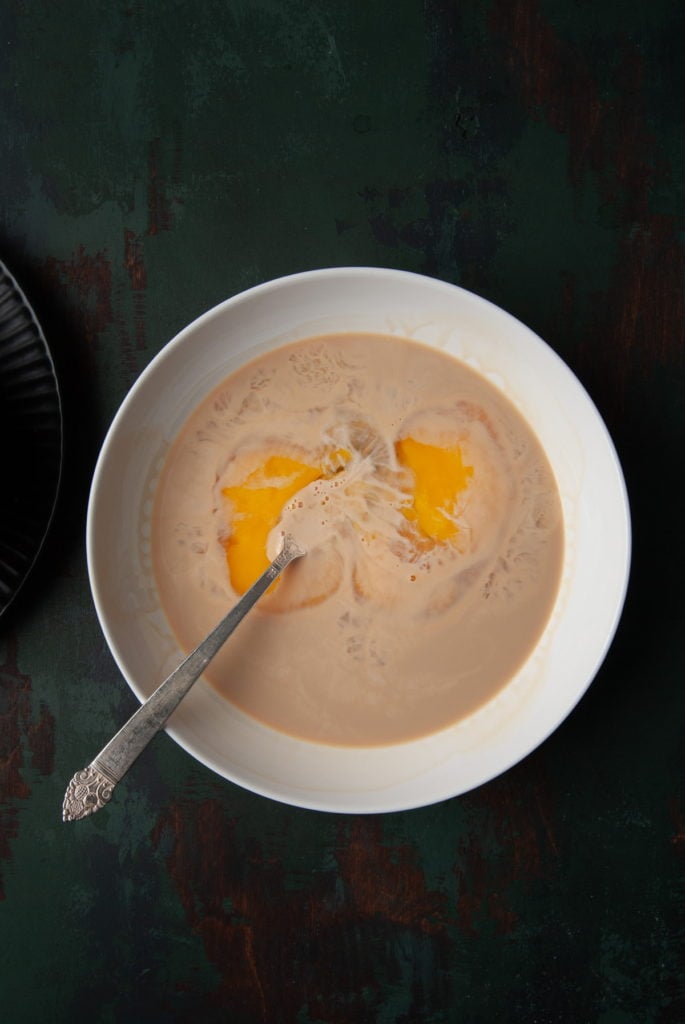 Whisking together eggs and Bailey's Irish Cream.