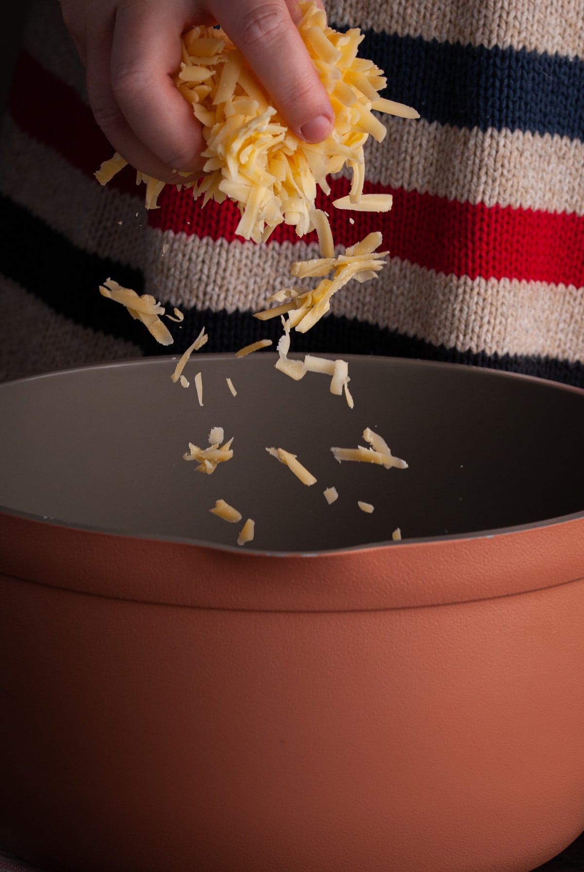 adding brie and gouda cheese to large pot