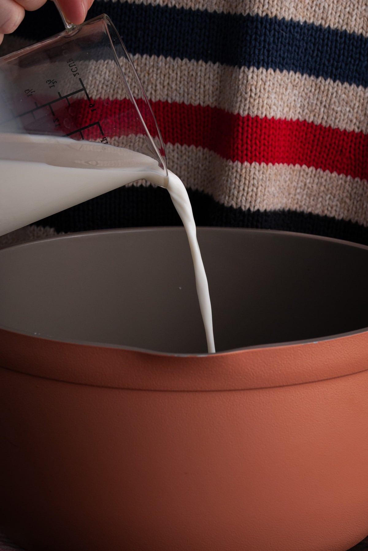 pouring milk into a large pot