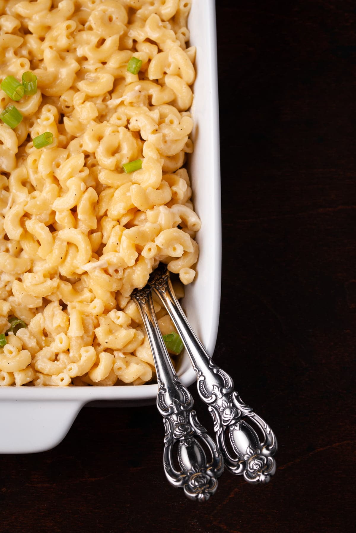 overhead shot of creamy mac n cheese with two serving spoons