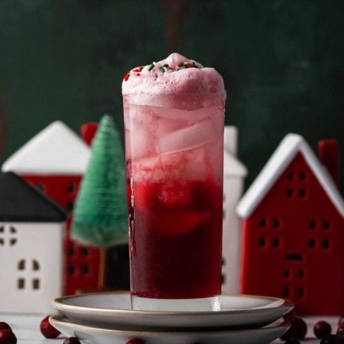 cranberry gin fizz surrounded by christmas decor