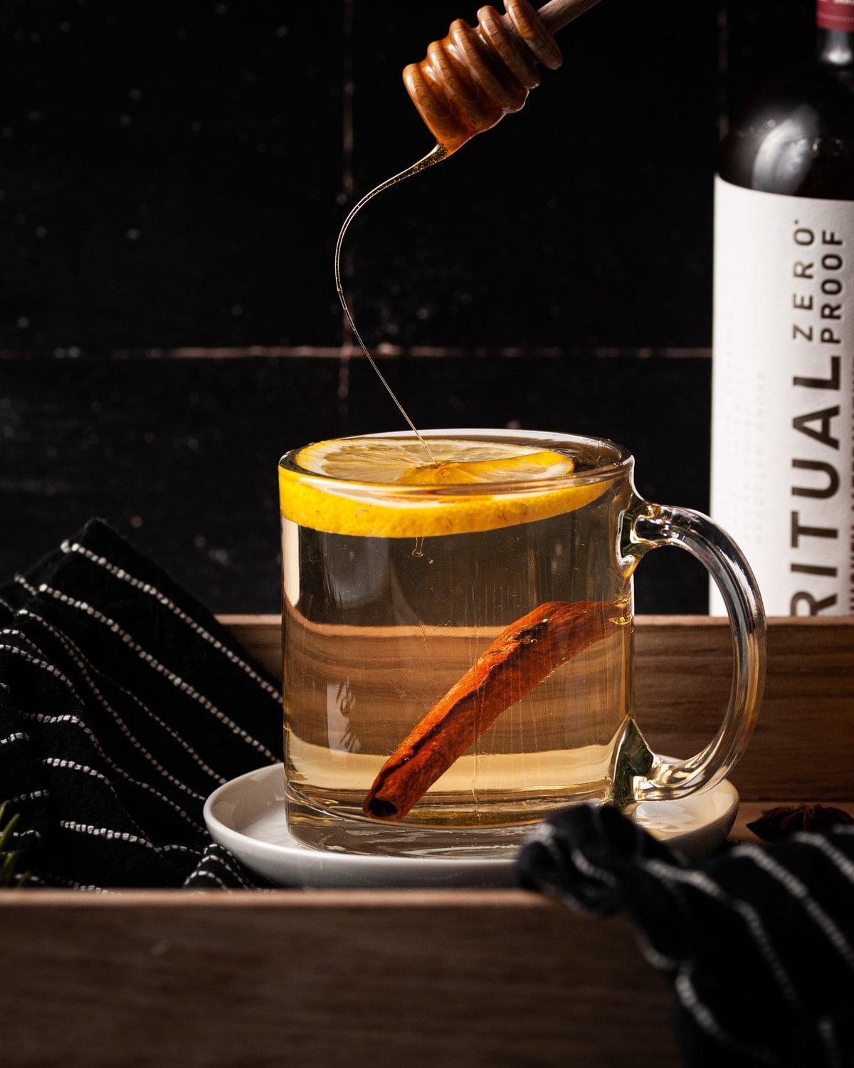 adding honey to hot toddy