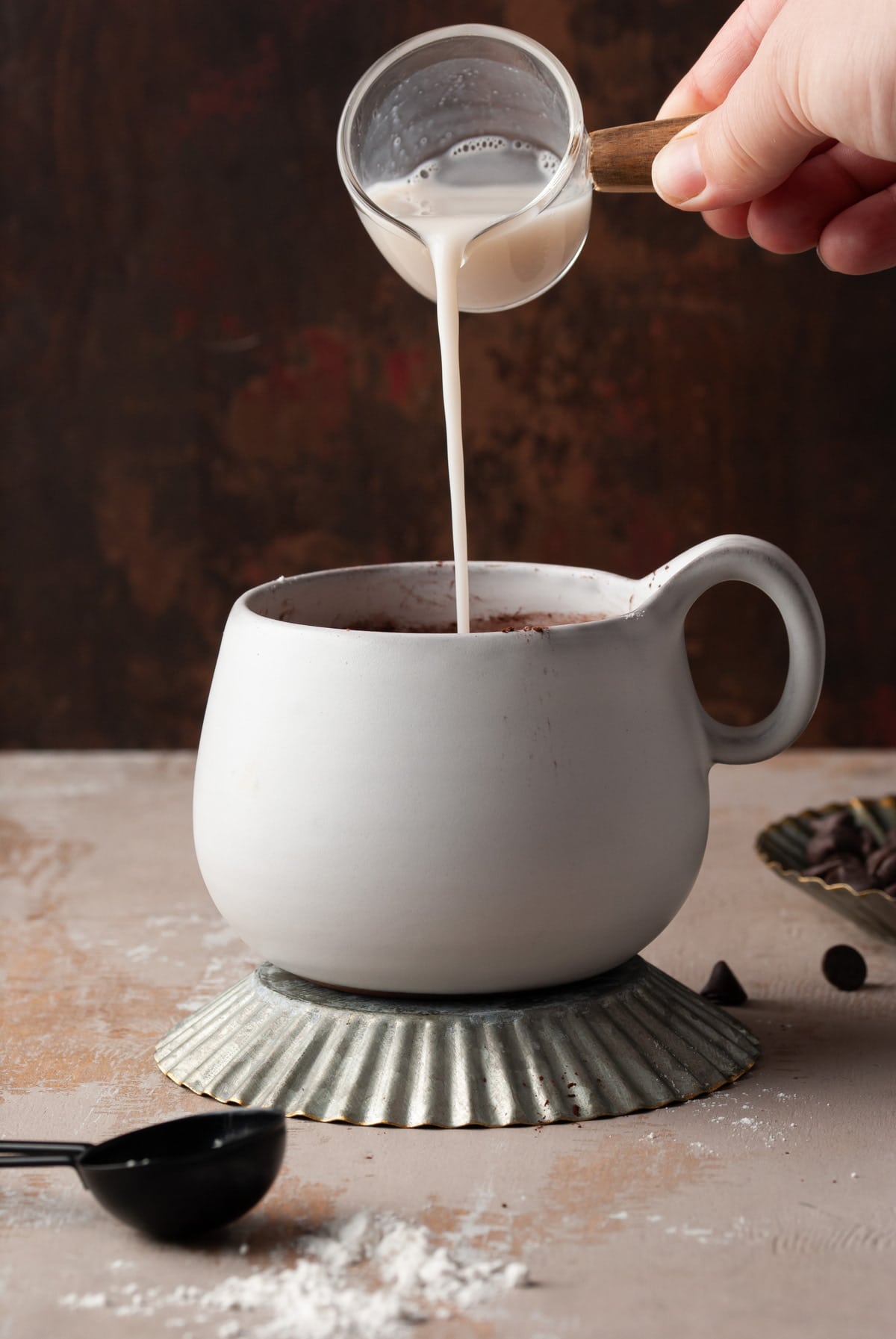 pouring almond milk into mug