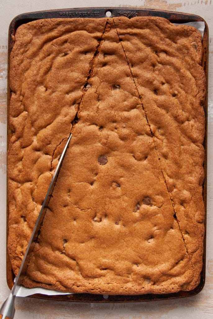 cutting cookie cake into a large triangle