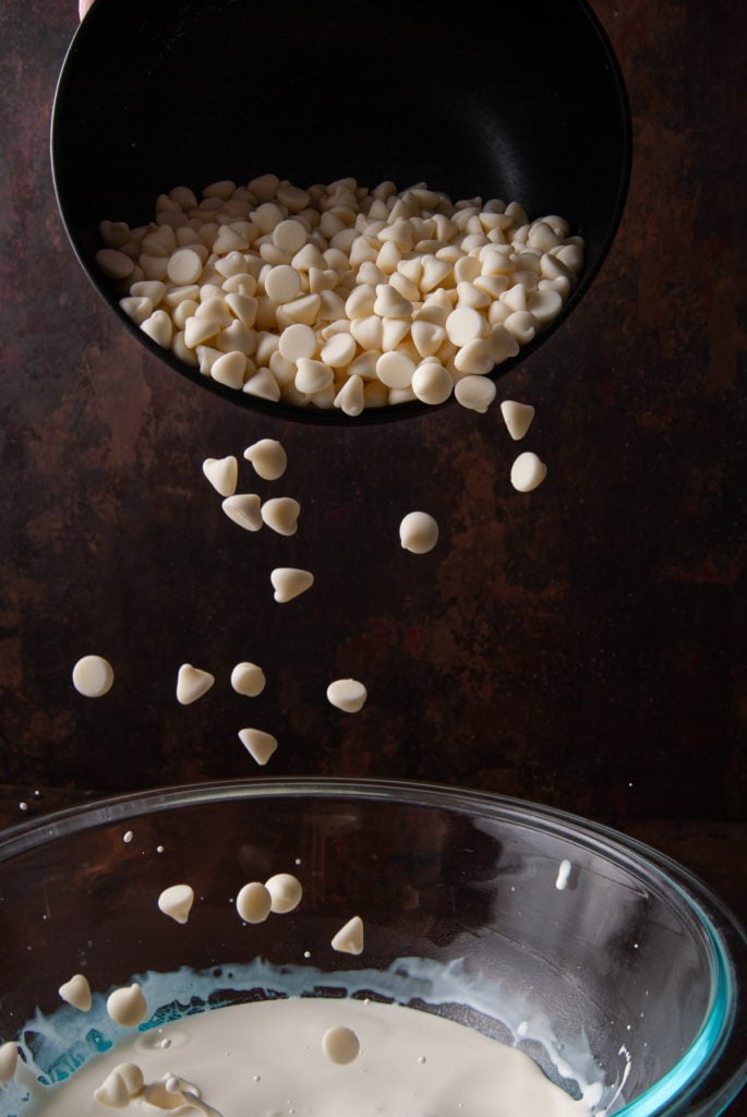 adding white chocolate chips to hot heavy cream